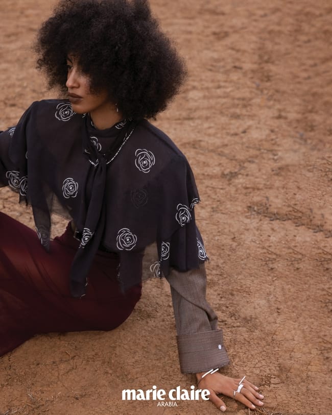 وشاح وتنورة من حرير الأورغنزا وقميص من الصوف وحزام من Prada عقد وسوار وخواتم من O! Jewelry